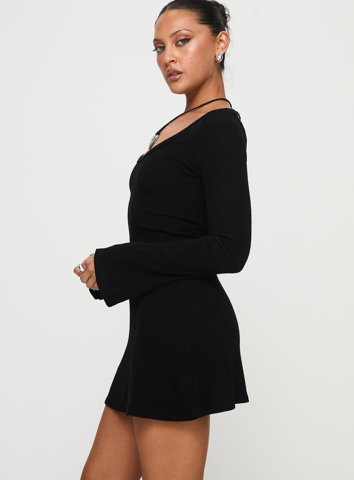 side view of model wearing Princess Polly Best Interest Long Sleeve Mini Dress Black Scoop Neck 