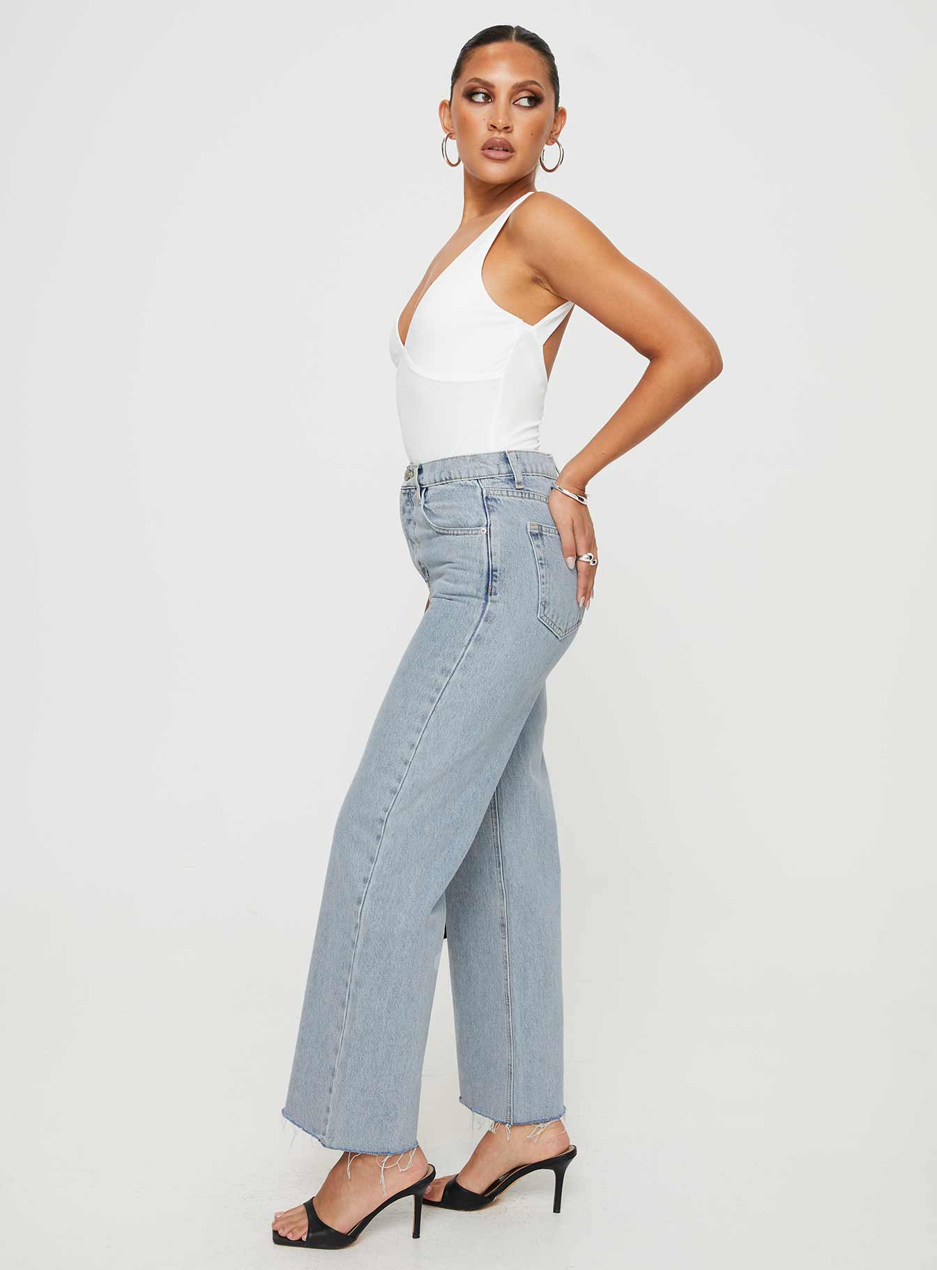 side view of model wearing Princess Polly Fawcett Jeans Light Wash Denim High Waisted 