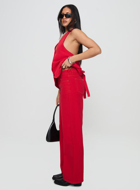 side view of model wearing Princess Polly Top Model Jeans Red Mid Rise 