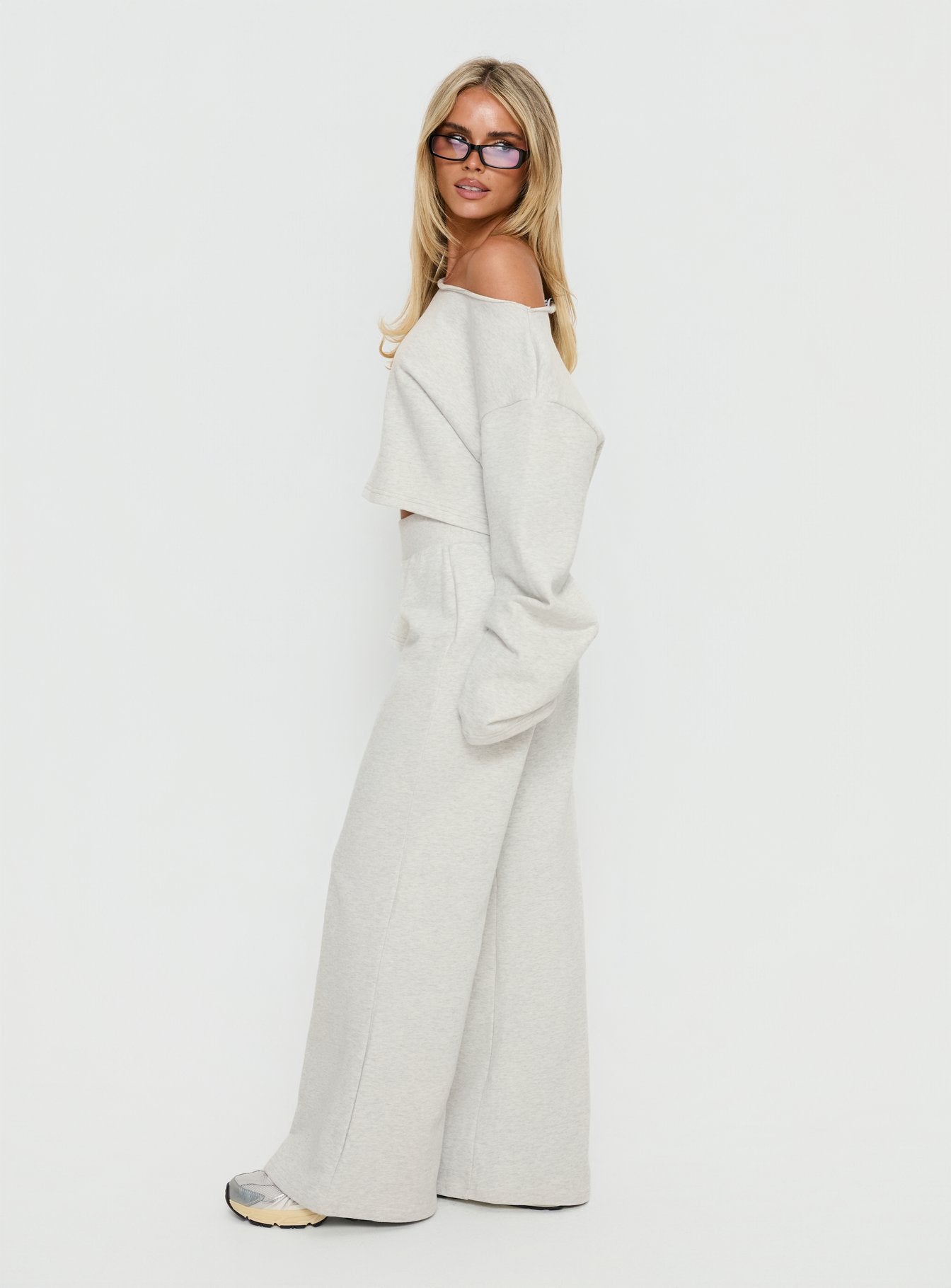 side view of model wearing Princess Polly Peaks Flared Track Pants Snow Marle Mid Rise Pants 