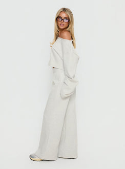 side view of model wearing Princess Polly Peaks Flared Track Pants Snow Marle Mid Rise Pants 