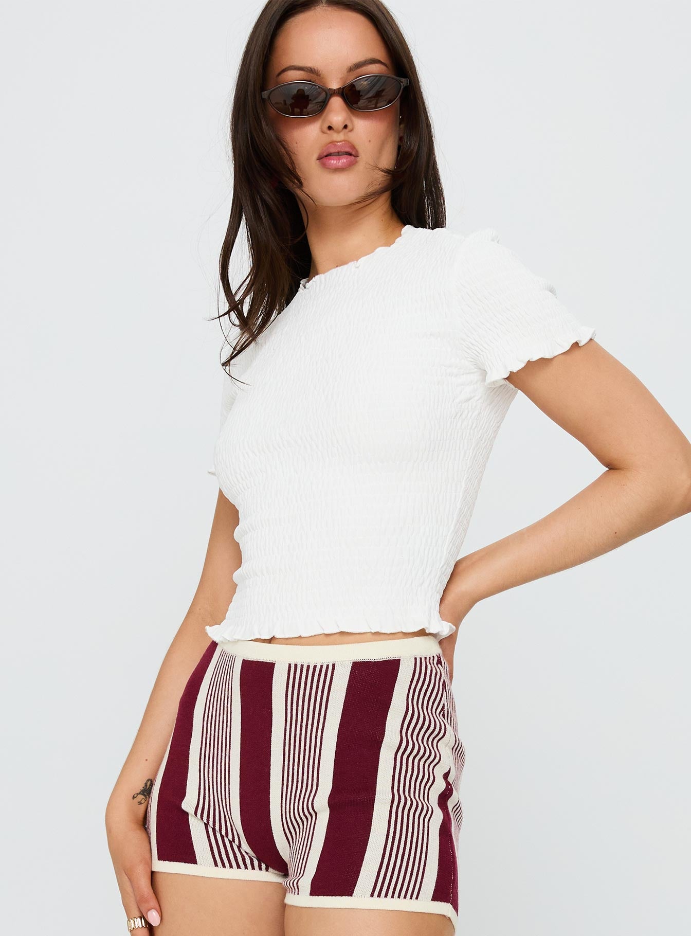 side view of model wearing Princess Polly Palm Reader Shirred Top White Short Sleeves Crew Neck 