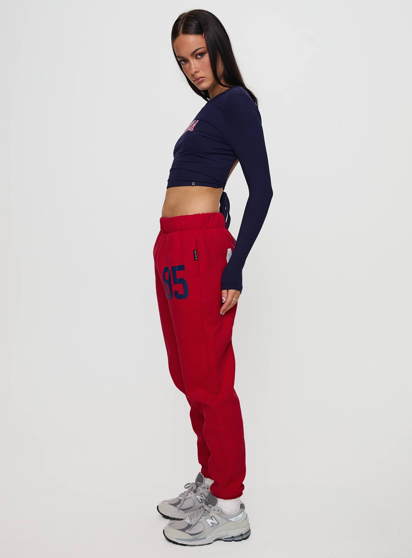 back view of model wearing Princess Polly U of A Sweatpants Red Low Rise Pants 