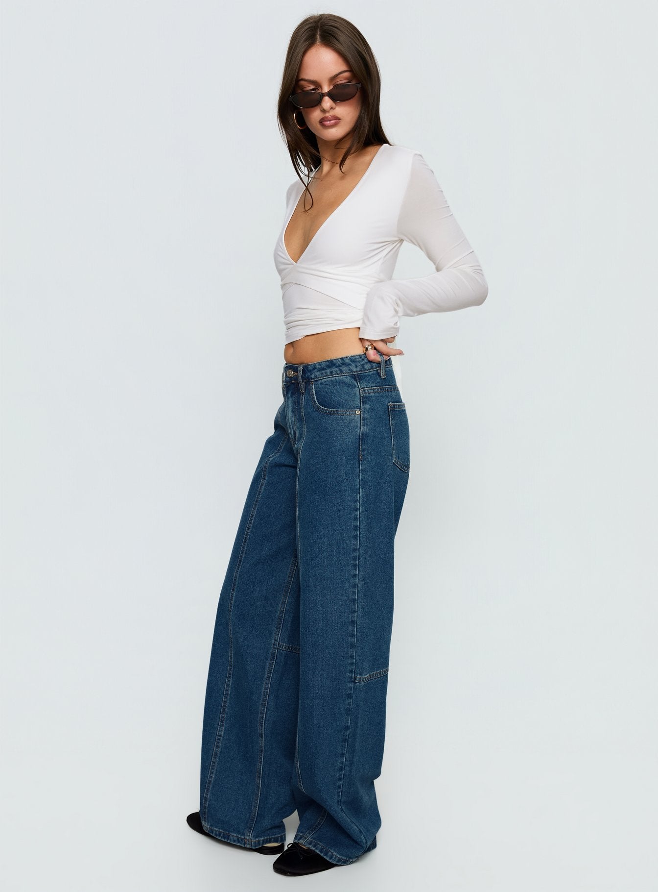 side view of model wearing Princess Polly Lando Low Rise Straight Leg Jeans Mid Blue Wash Mid Rise Jeans 