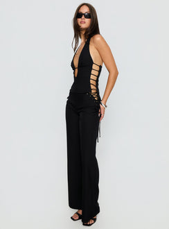 side view of model wearing Princess Polly Riane Lace Up Pants Black Mid Rise Pants 