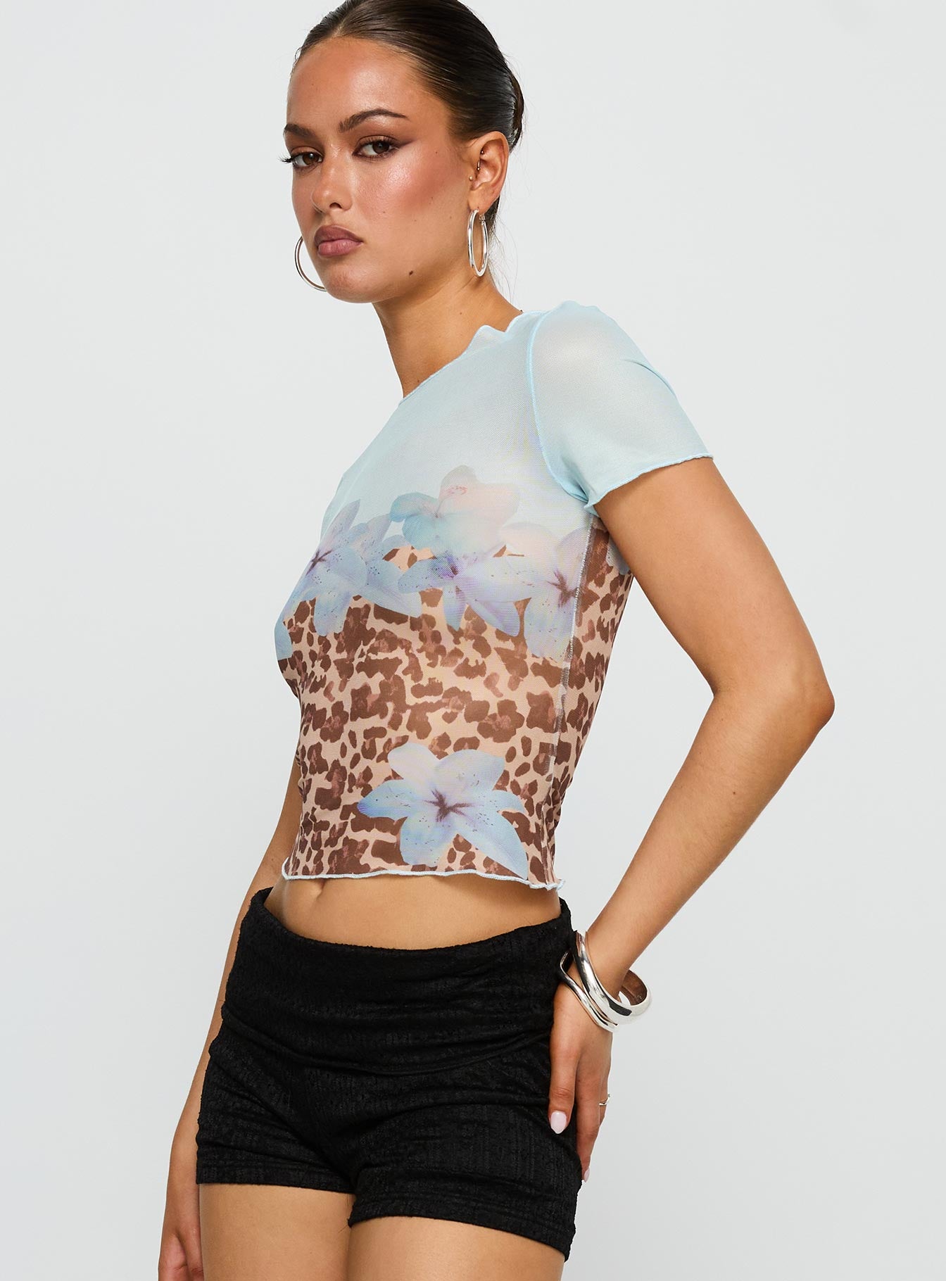 side view of model wearing Princess Polly Pop Quiz Mesh Top Blue / Leopard Short Sleeves Crew Neck 