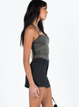 Black mini skirt Mid to low rise Double button and zip fastening Belt looped waist Four pocket design
