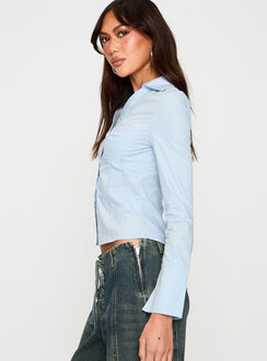 side view of model wearing Princess Polly Zifa Shirt Blue Full Sleeves V-Neck 