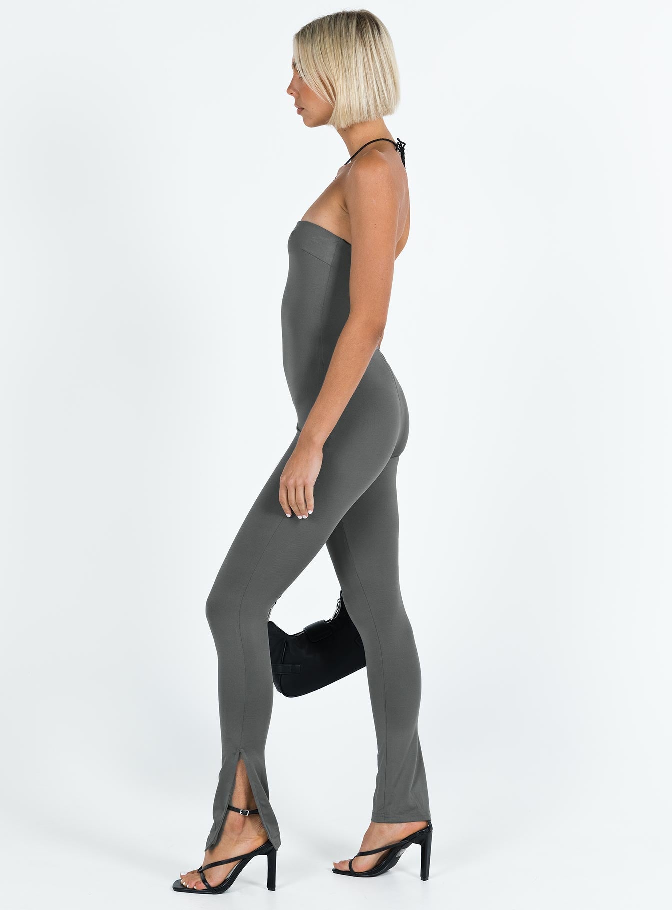 Strapless jumpsuit Inner silicone strip at bust Invisible zip fastening at back Split at cuff Slim leg Fully lined