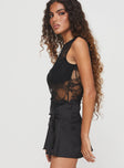 side view of model wearing Princess Polly Feelix Sleeveless Lace Bodysuit Black Sleeveless 