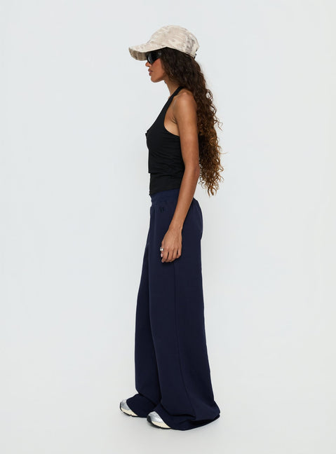 side view of model wearing Princess Polly Summits Flared Track Pants Navy Mid Rise Pants 