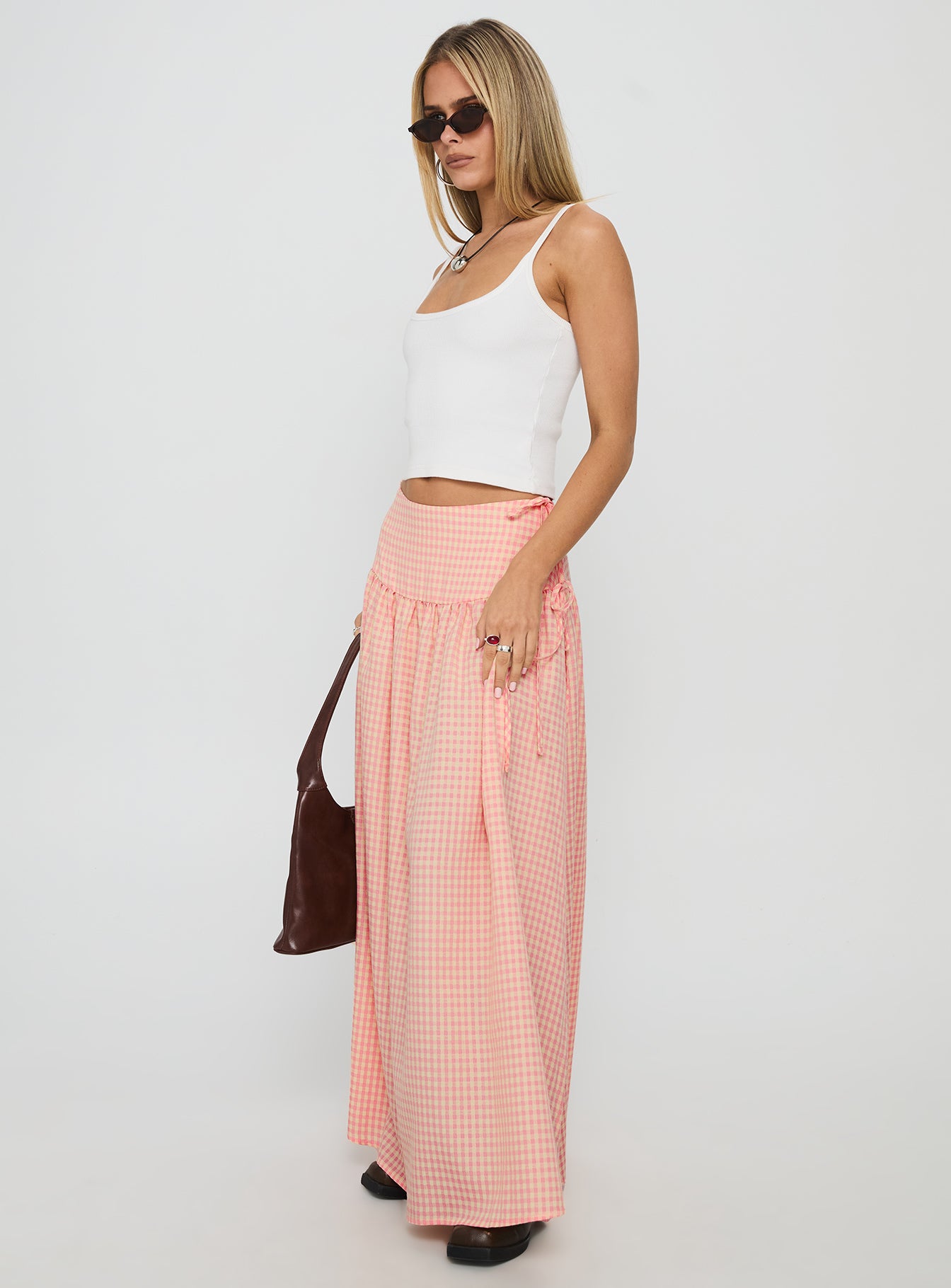   side view of model wearing Princess Polly Analeah Tie Side Midi Skirt Orange Check Maxi 