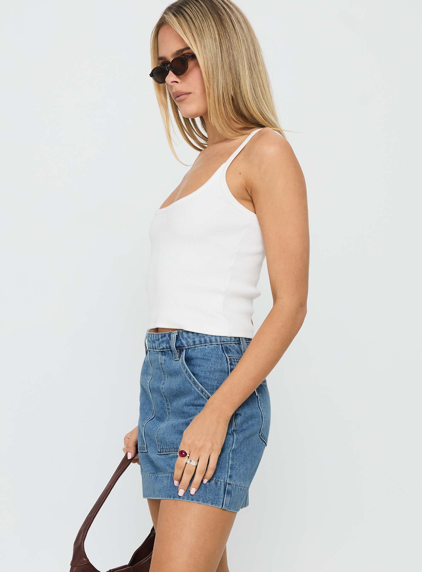   side view of model wearing Princess Polly Hughes Mini Skirt Light Blue Denim Mini Skirts 