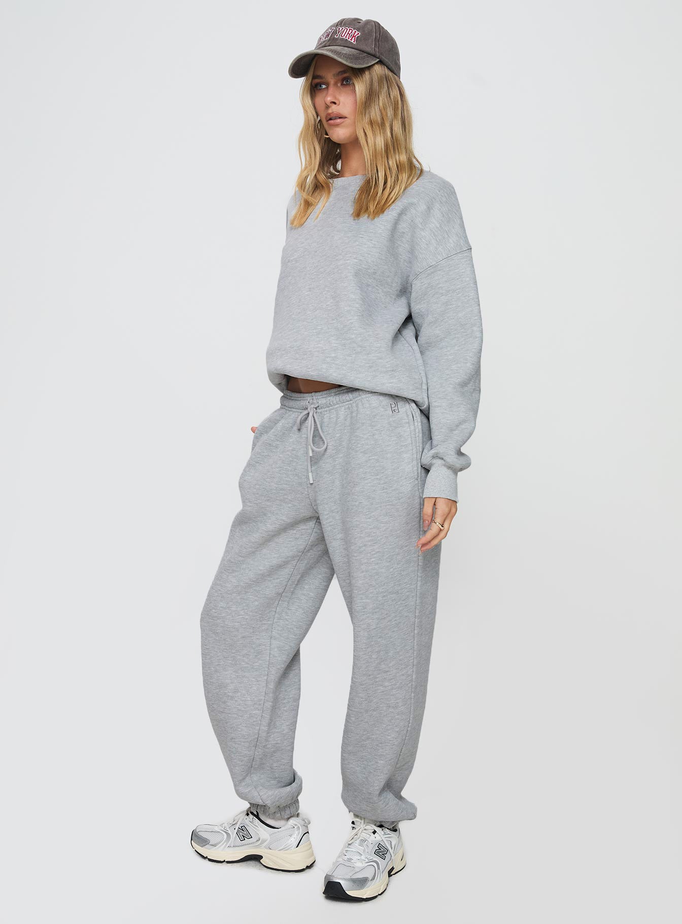side view of model wearing Princess Polly Dream Fleece Ankle Cuff Sweatpants Grey Marle High Waisted Pants 