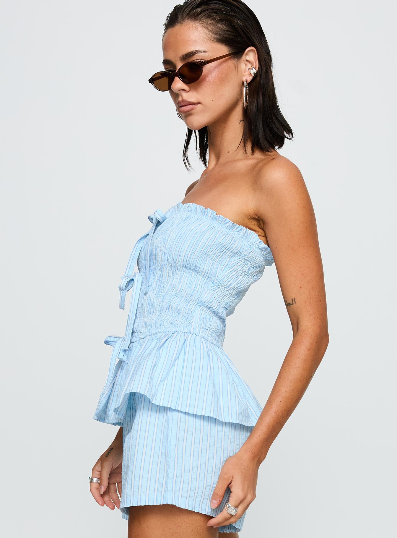 side view of model wearing Princess Polly Saskea Strapless Top Blue Sleeveless straight 