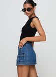   side view of model wearing Princess Polly Pacific Coast Denim Cargo Skirt Dark Wash Mini Skirts 