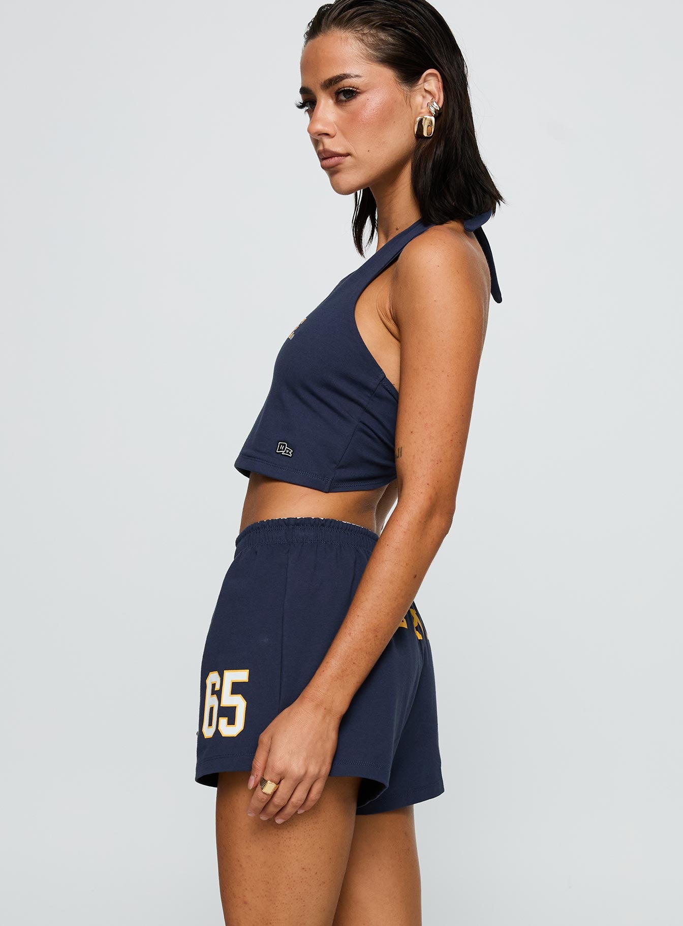 side view of model wearing Princess Polly UC Irvine Soffee Shorts Blue High Waisted Shorts 