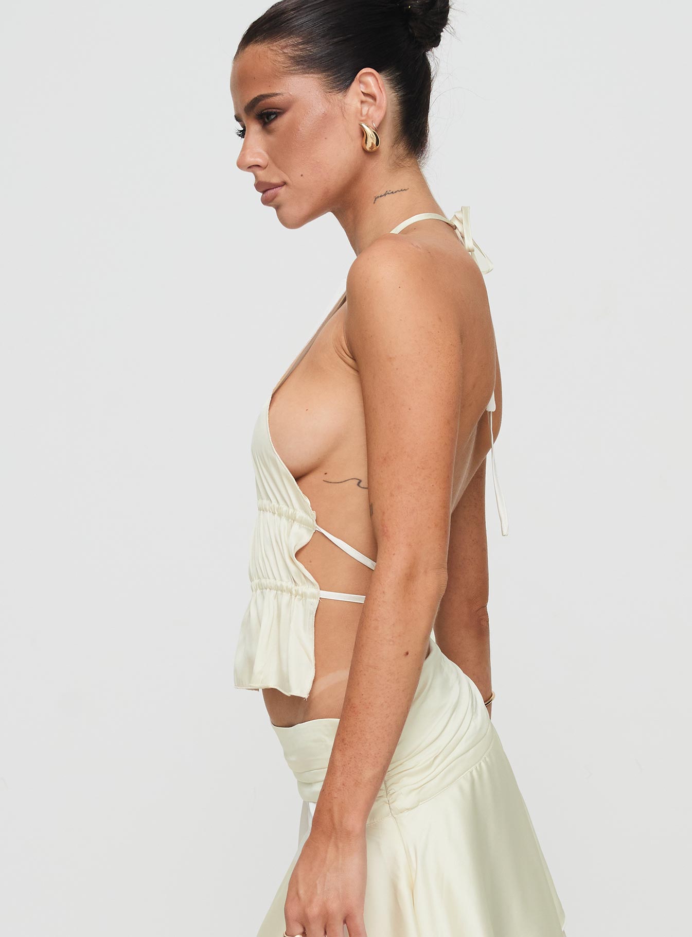 side view of model wearing Princess Polly Legacy Halter Top Ivory Sleeveless High Neck 