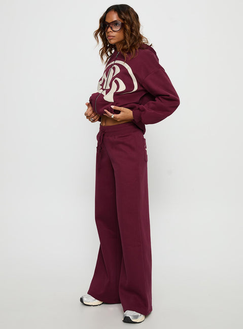side view of model wearing Princess Polly Princess Polly Stargirl Wide Leg Sweat Pants Burgundy High Rise Pants 