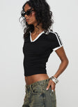 side view of model wearing Princess Polly Kortney Top Black Short Sleeves V-Neck 