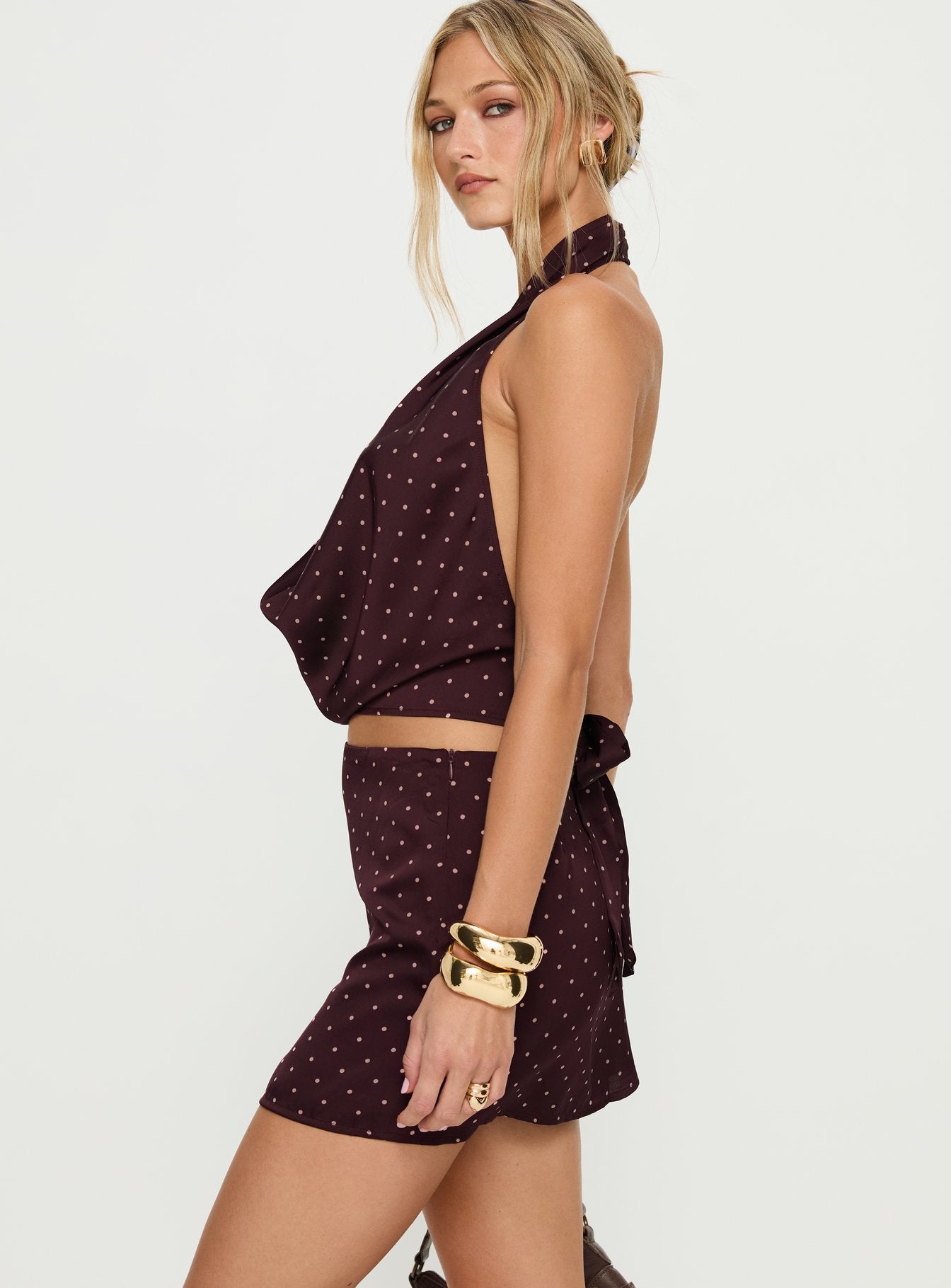   side view of model wearing Princess Polly Keiana Mini Skirt Burgundy / Pink Polka Mini Skirts 