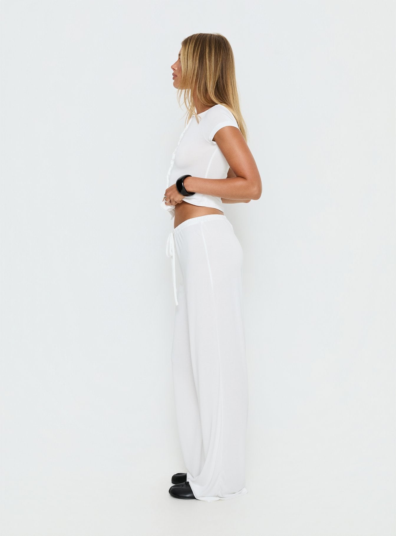 side view of model wearing Princess Polly Gavrielle Jersey Wide Leg Pants White Mid Rise Pants 