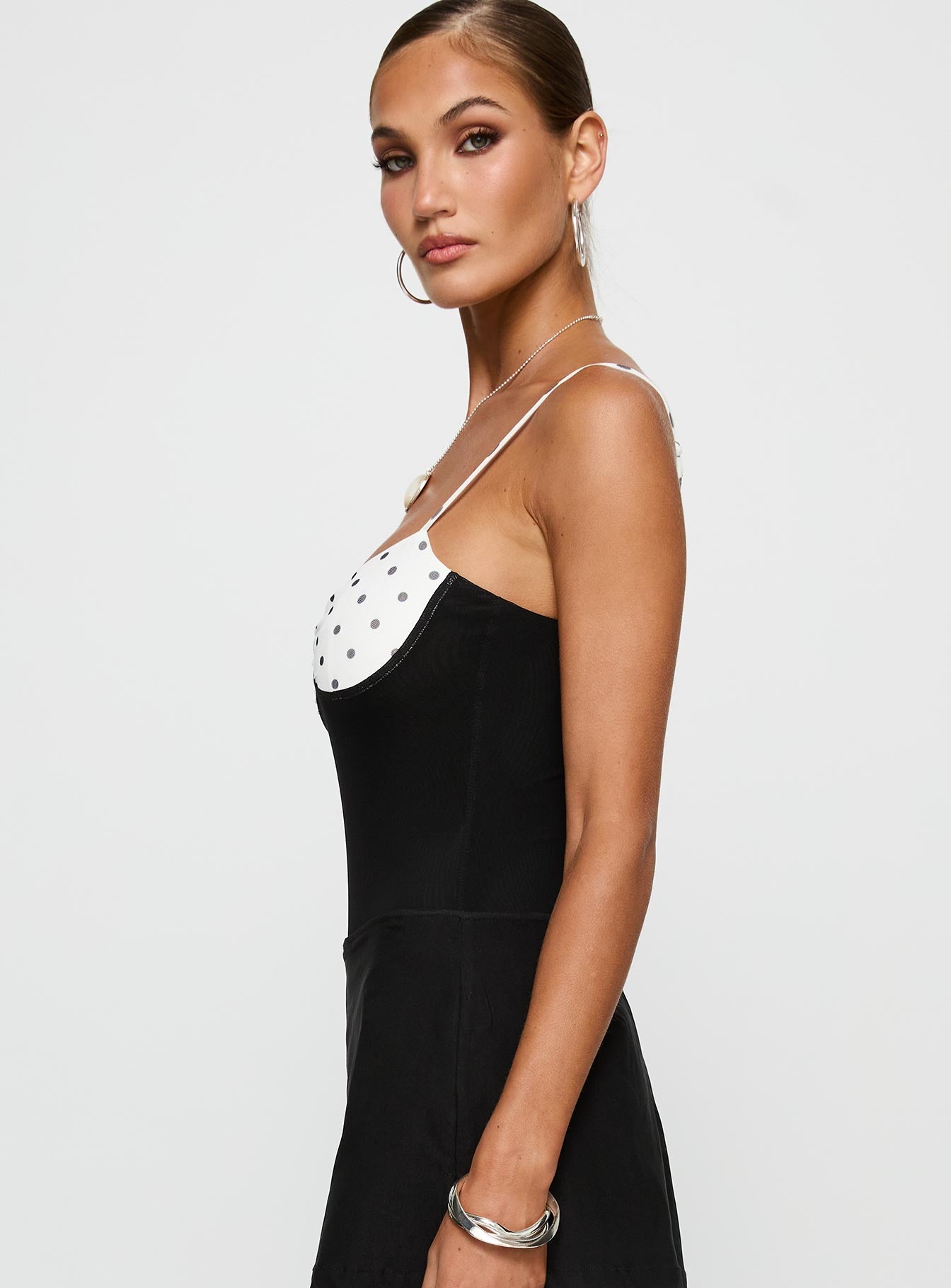 side view of model wearing Princess Polly Evette Bodysuit Black / White Sleeveless 