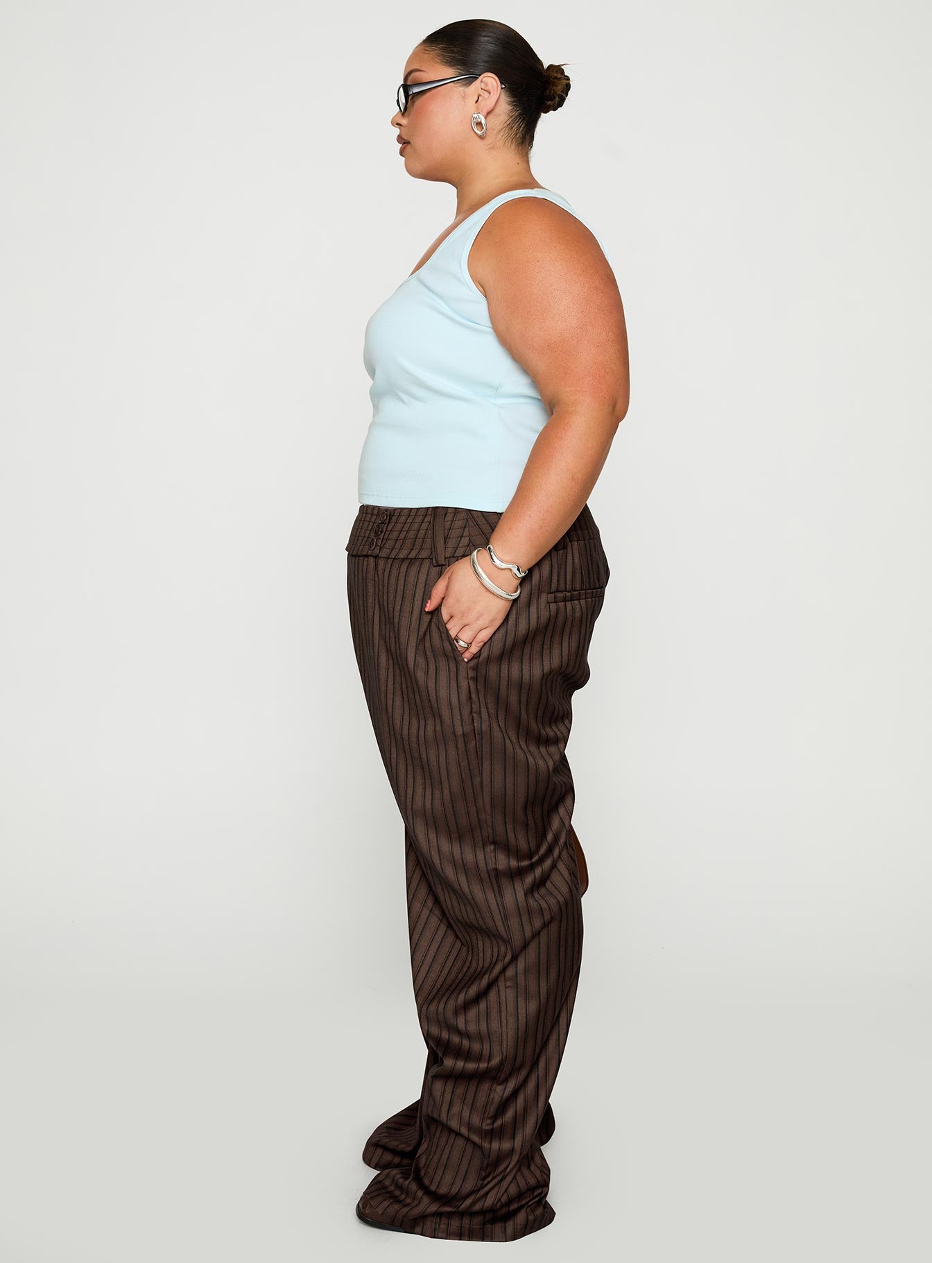 side view of model wearing Princess Polly Cedars Low Rise Pant Brown Stripe Curve Low Rise Pants 