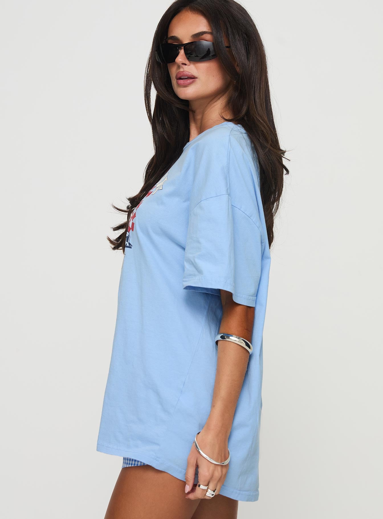 side view of model wearing Princess Polly Races 1996 Oversized Tee Blue Half Sleeves Crew Neck 