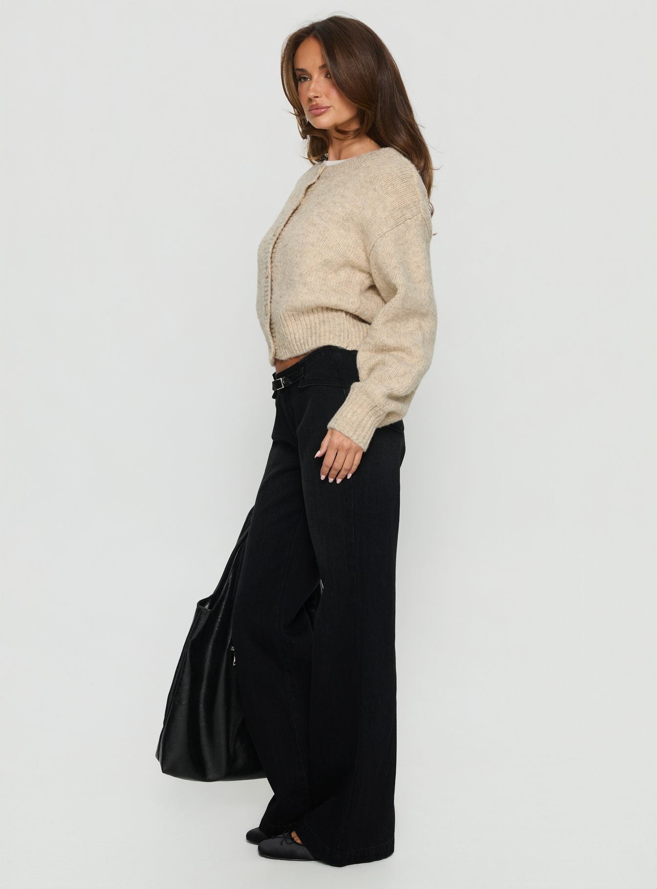 side view of model wearing Princess Polly Slow Ride Mid Rise Bootleg Belted Jeans Washed Black Mid Rise Jeans 