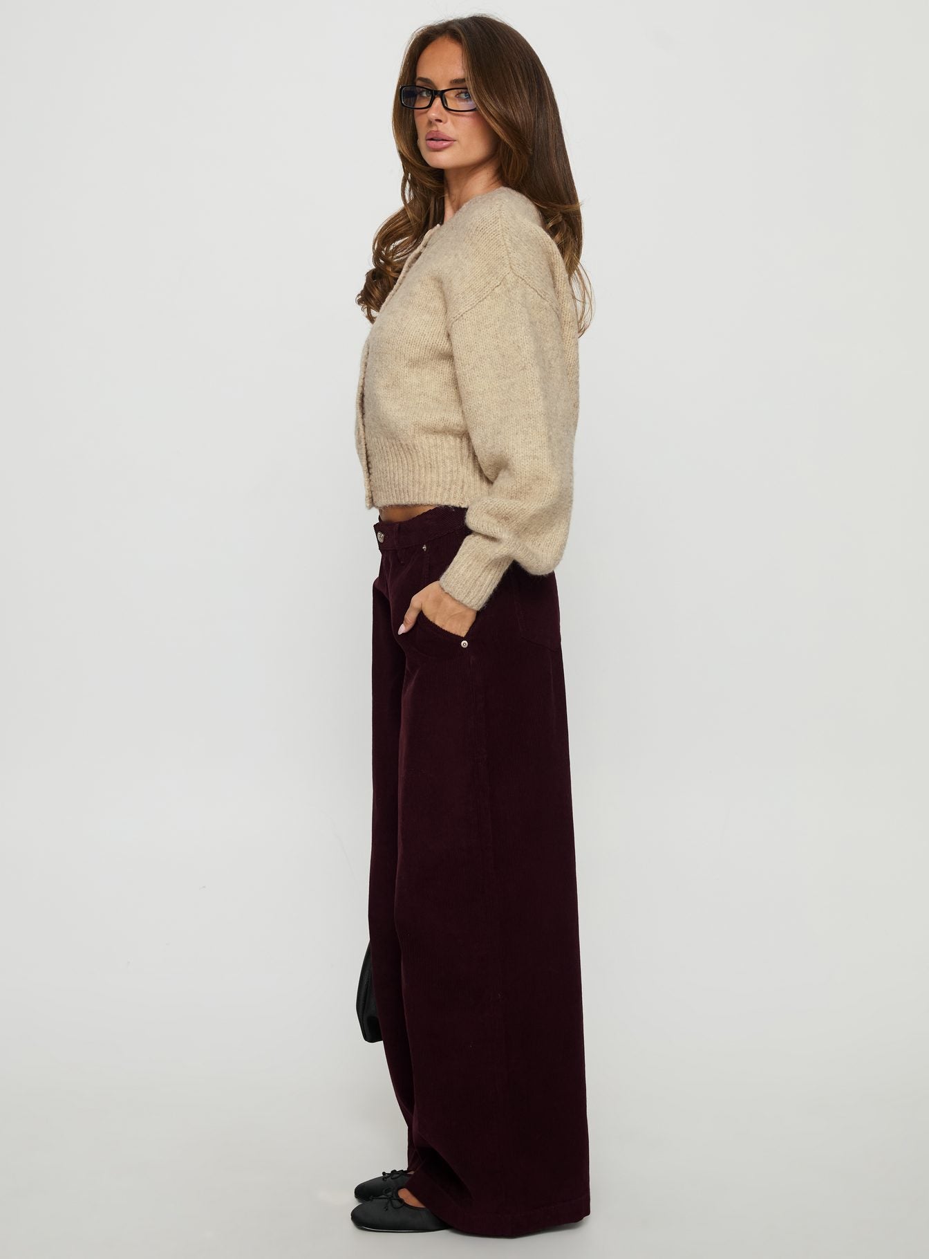 side view of model wearing Princess Polly Jacynda Low Waist Wide Leg Corduroy Jeans Currant Mid Rise Jeans 
