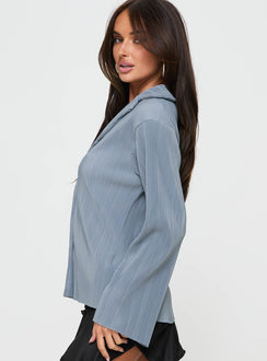 side view of model wearing Princess Polly Louie Pleated Shirt Blue Full Sleeves V-Neck 