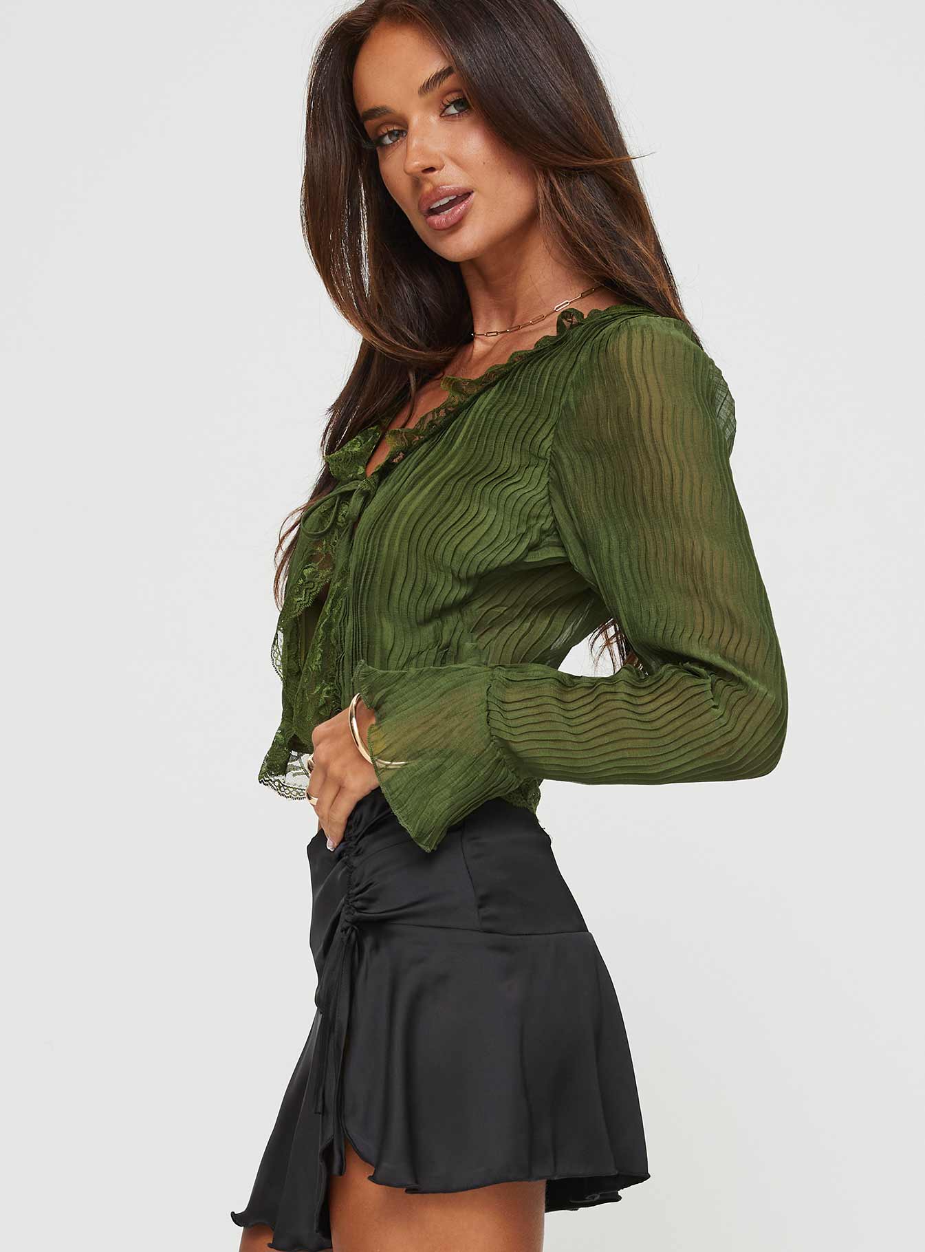 side view of model wearing Princess Polly Kareela Long Sleeve Top Green Full Sleeves V-Neck 