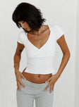 front view of model wearing Princess Polly Maz Top White Short Sleeves Plunger 