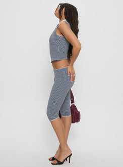 side view of model wearing Princess Polly Tuka Capri Navy Gingham Mid Rise Pants 