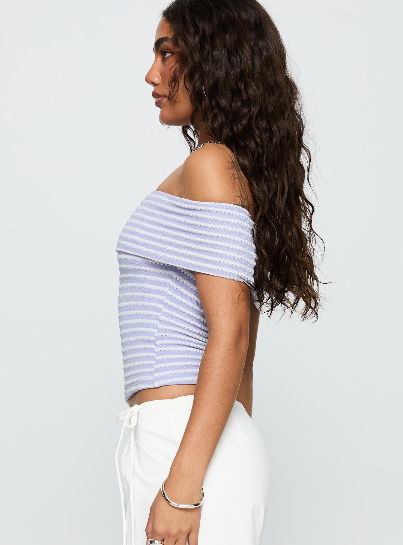 side view of model wearing Princess Polly Ausha Off Shoulder Top Lilac Stripe Short Sleeves straight 