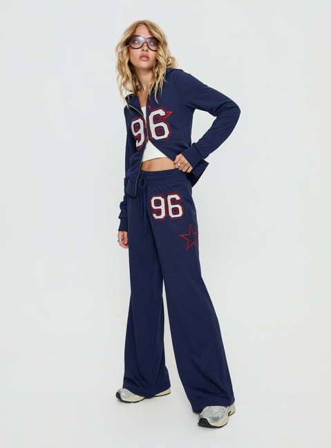 side view of model wearing Princess Polly Kari Distressed Patch Track Pant Navy Multi High Rise Pants 