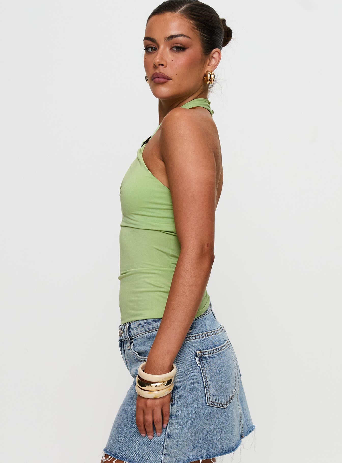 side view of model wearing Princess Polly Quell Top Green Sleeveless High Neck 