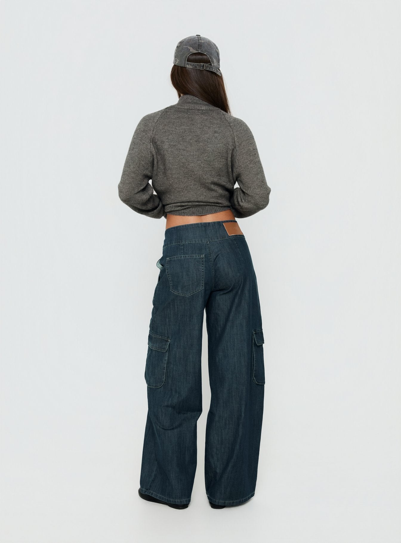 Designed with the Nikoletta Mid Rise Wide Leg Cargo Jeans Dark Blue Wash in womens-jeans with mid-rise back view of model wearing