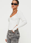Long sleeve top Knit material, twist detail at bust, top hem angles down  Good stretch, unlined