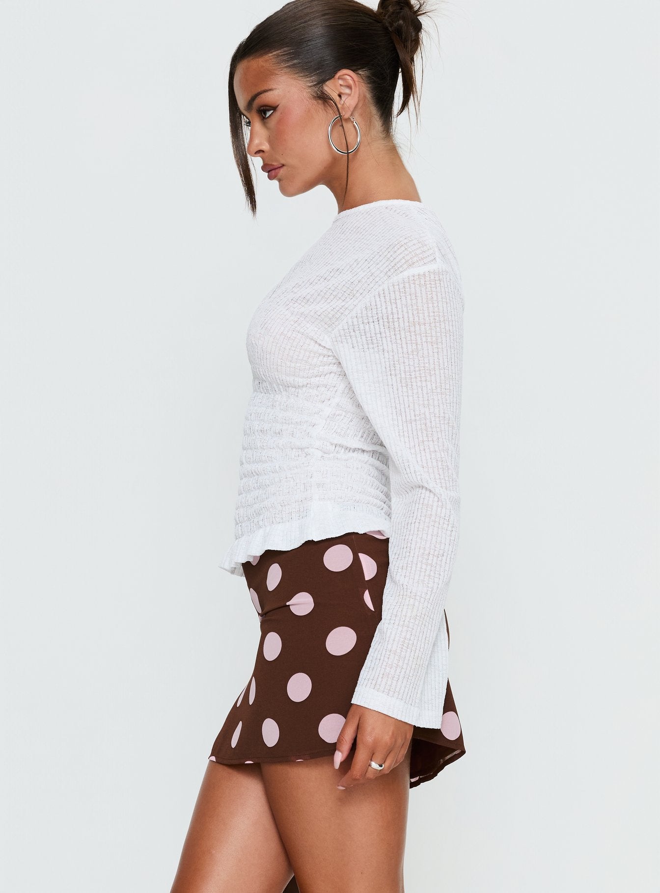   side view of model wearing Princess Polly Adelaida Mini Skirt Brown / Pink Polka Mini Skirts 