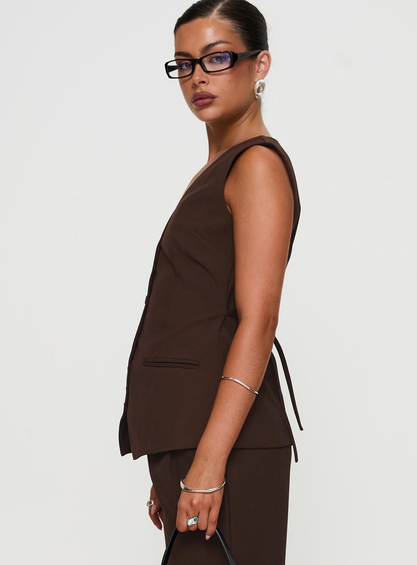side view of model wearing Princess Polly Ambient Longline Button Up Top Chocolate Sleeveless V-Neck 