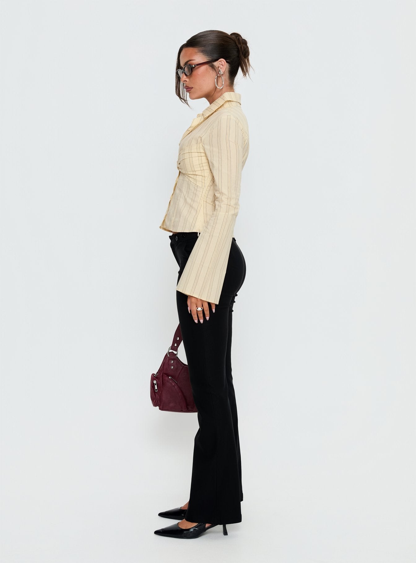 side view of model wearing Princess Polly Dariana Flare Pants Black Mid Rise Pants 
