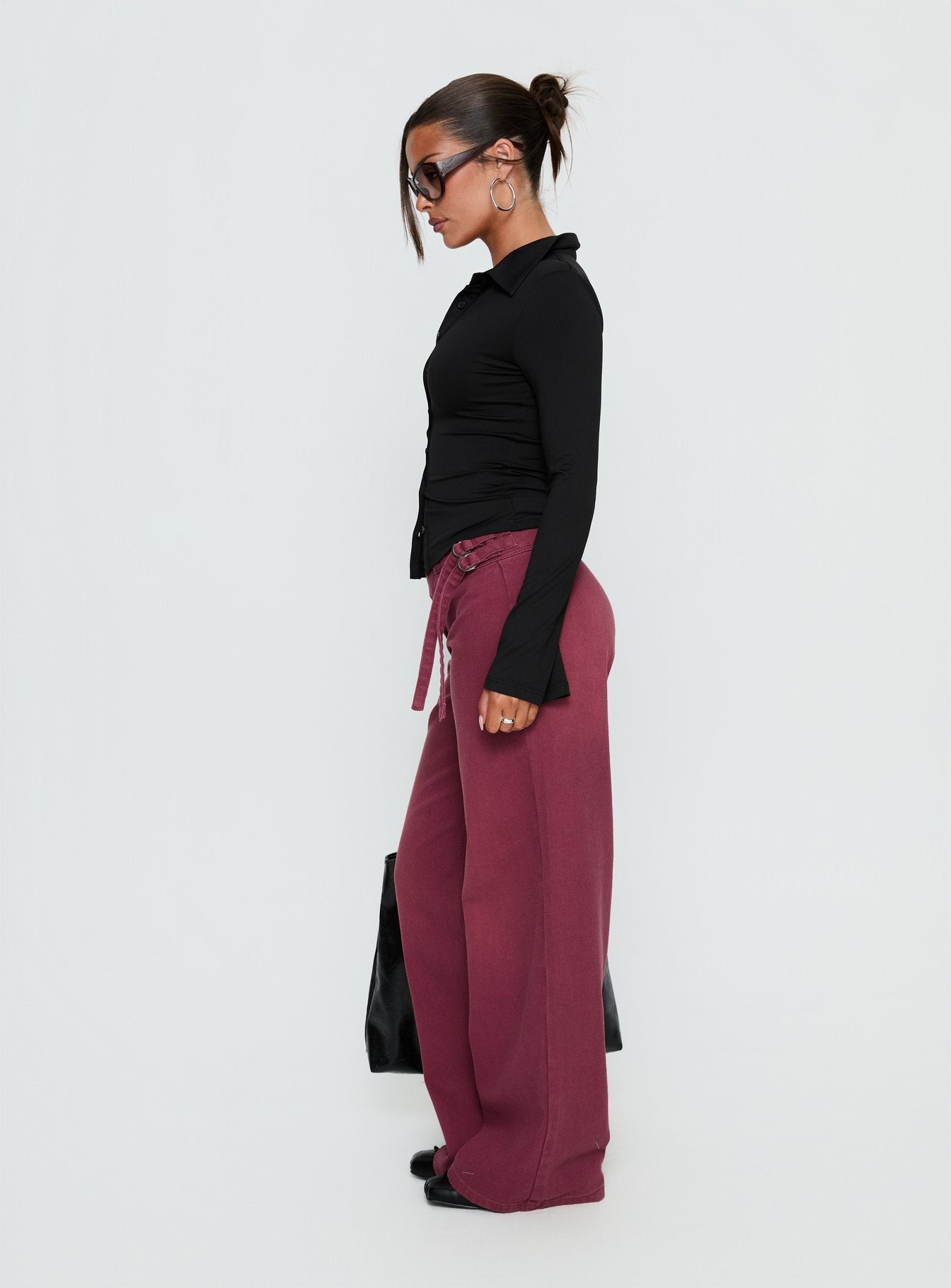 side view of model wearing Princess Polly Boxie Mid Rise Wide Leg Jeans Washed Burgundy Mid Rise Jeans 