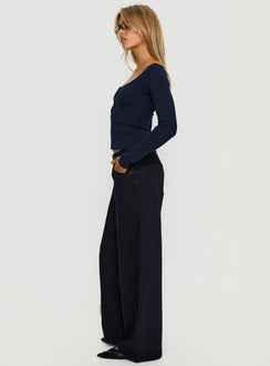 side view of model wearing Princess Polly Supercut Low Rise Baggy Pleat Jeans Washed Black Low Rise Jeans 