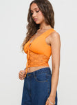 side view of model wearing Princess Polly Isolde Top Orange Sleeveless V-Neck 