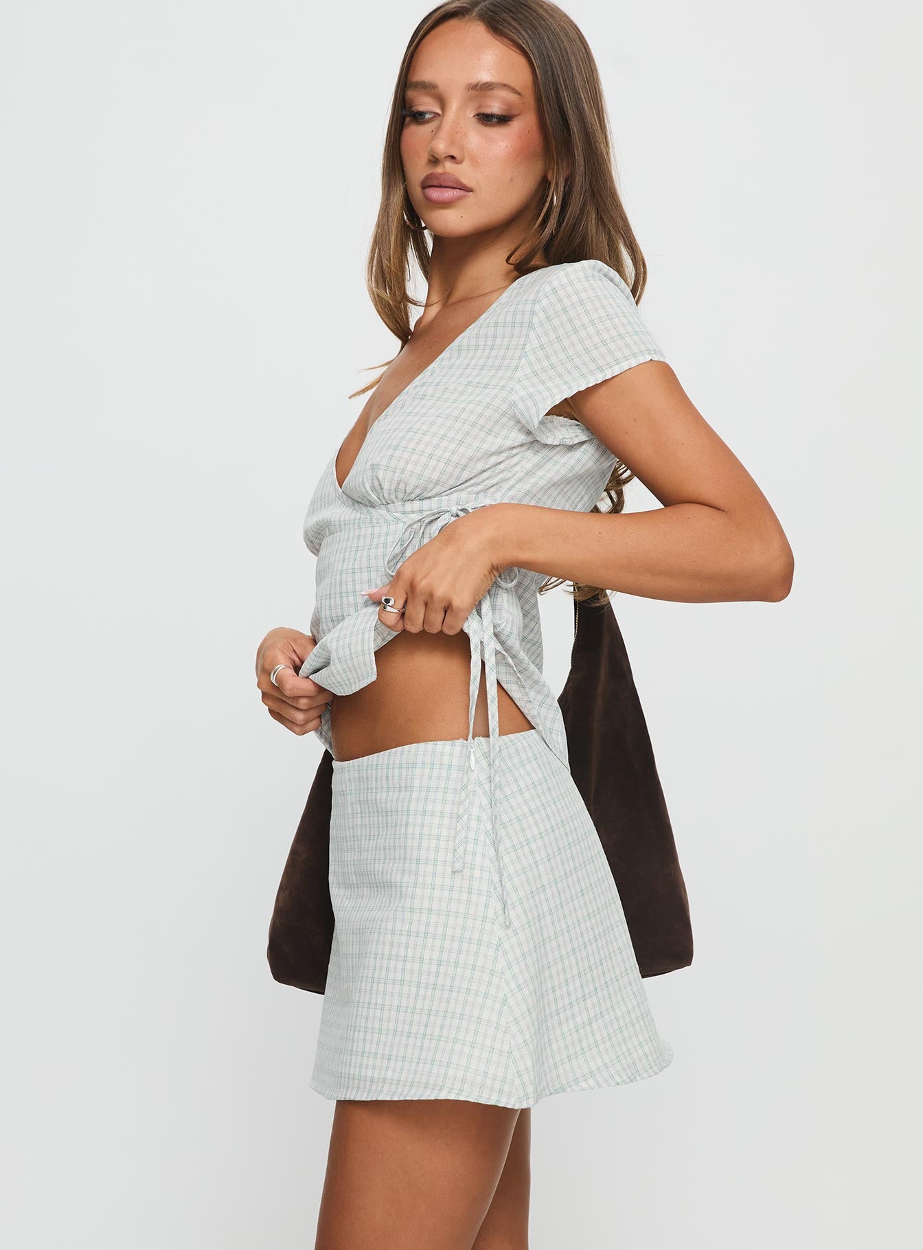   side view of model wearing Princess Polly Prominent Mini Skirt Green Check Mini Skirts 