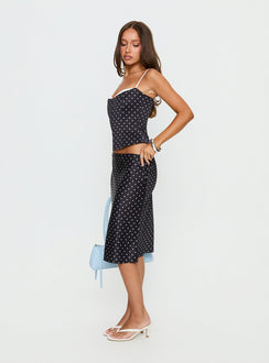   side view of model wearing Princess Polly Somani Satin Midi Skirt Black Polka Dot Midi Skirts 
