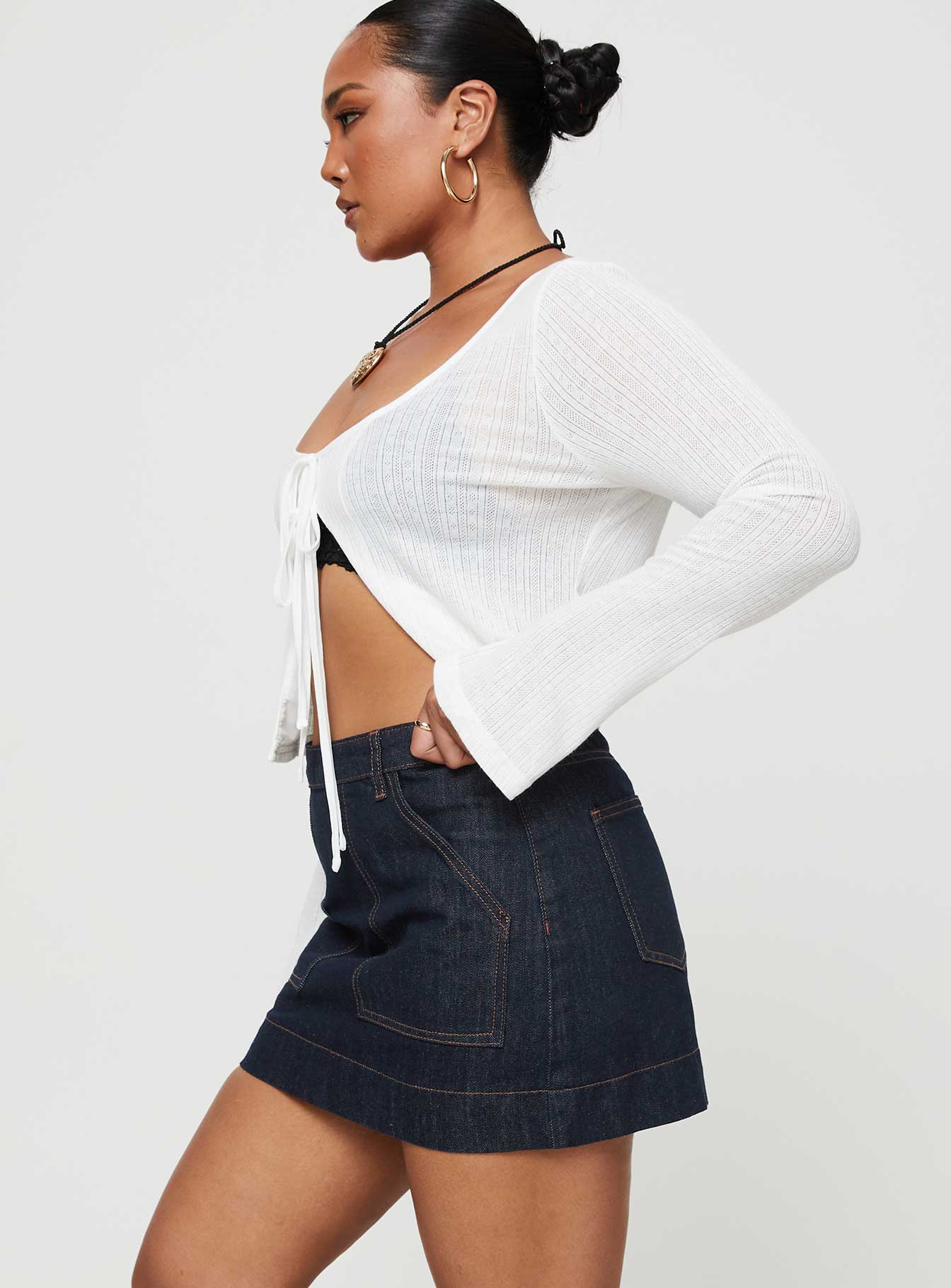   side view of model wearing Princess Polly Hughes Mini Skirt Dark Wash Denim Petite Mini Skirts 