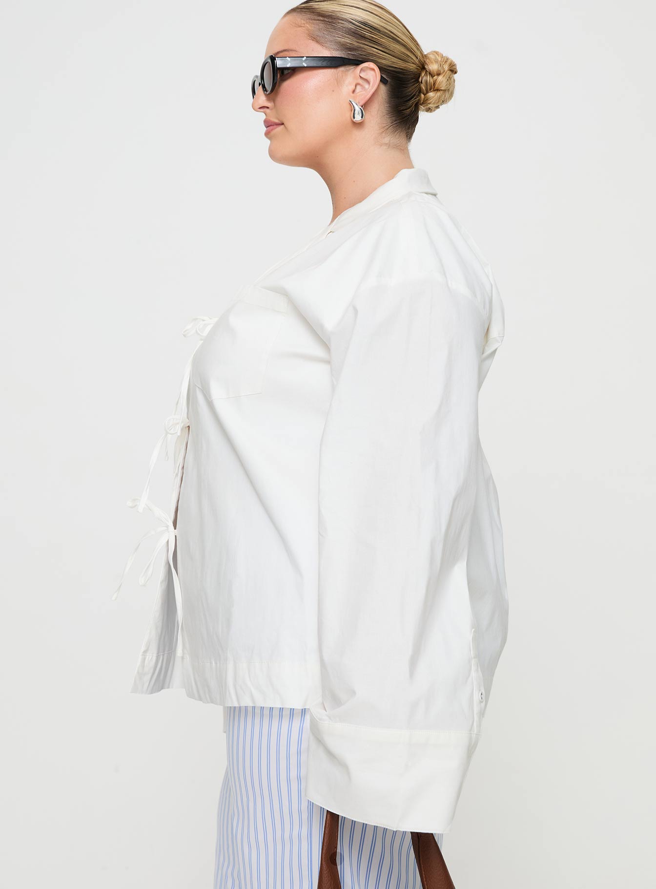 side view of model wearing Princess Polly Spiri Shirt White Curve Full Sleeves V-Neck 